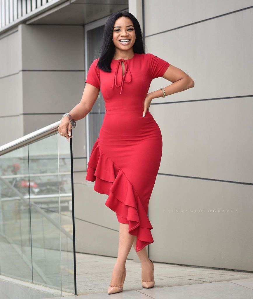  Serwaa Amihere looks all classy in his red dress standing infront of her Office Building