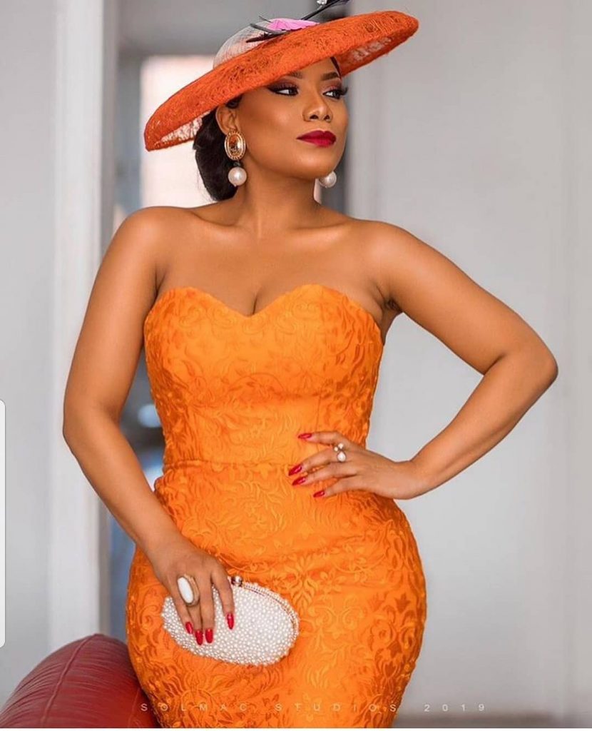 Zynnell Zuh dazzles in an Orange Lace Gown with Hat